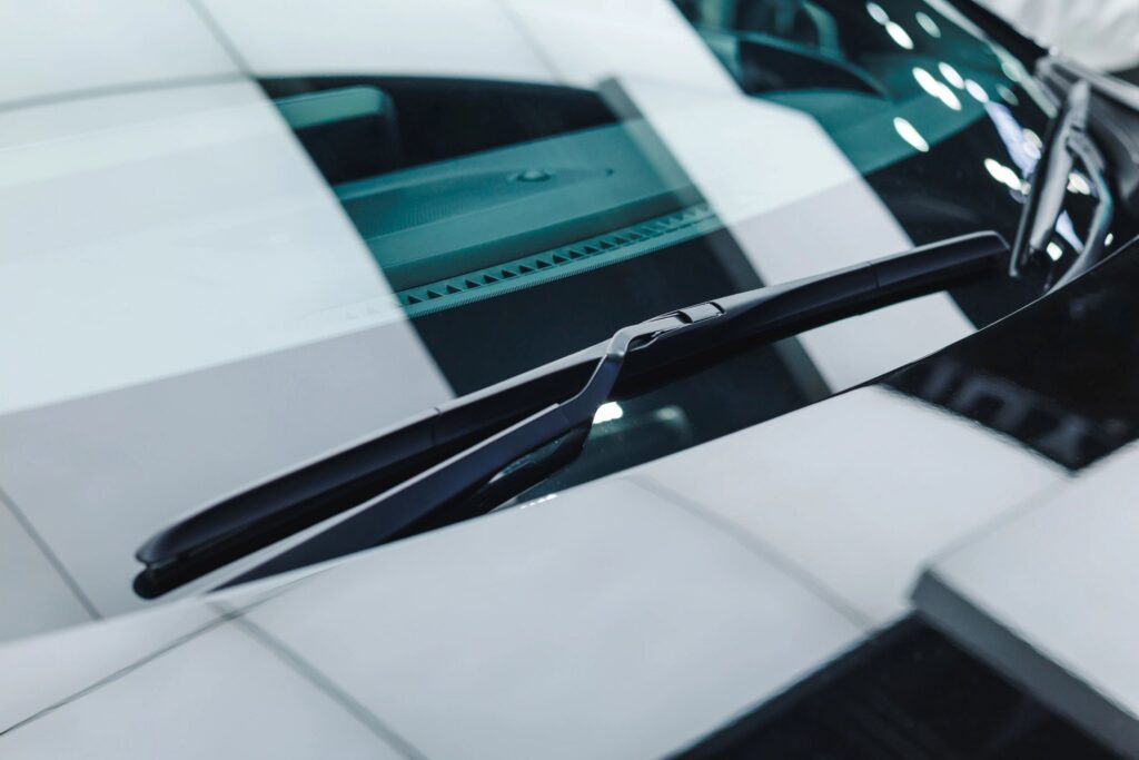 Modern car font glass windshield wiper clean new closeup shot